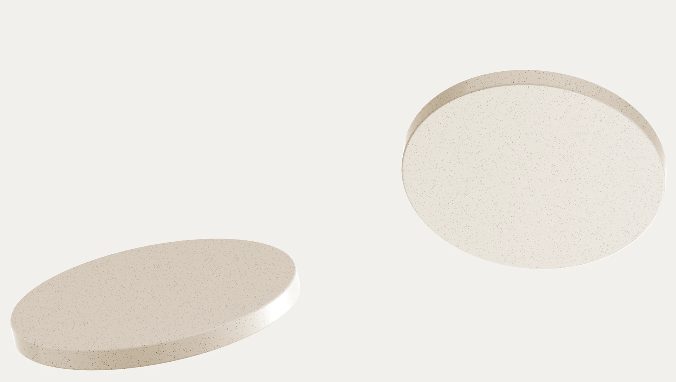 Two round, white tablets on a plain background. One lies flat, while the other is tilted. The image conveys simplicity and minimalism.